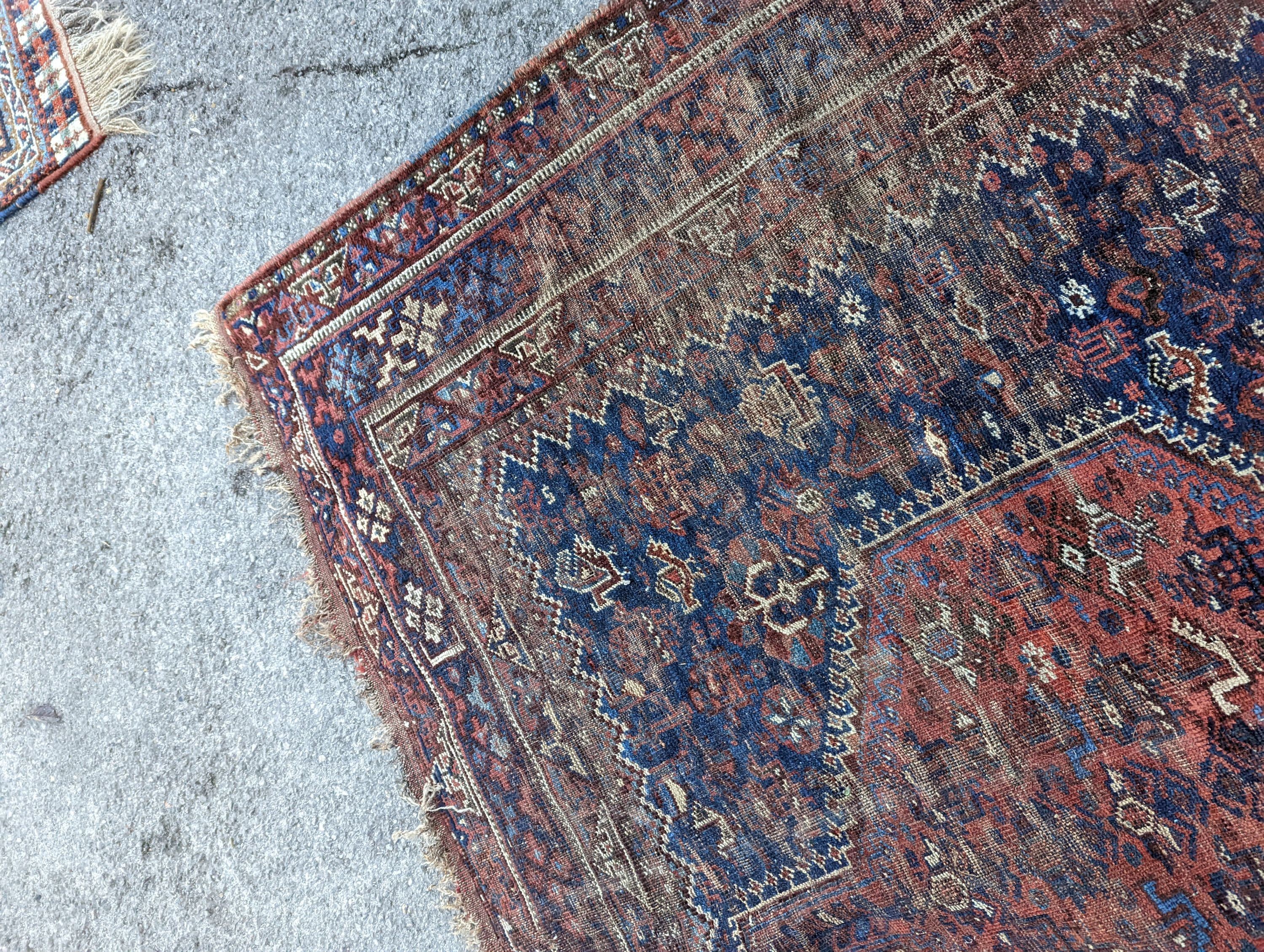 An antique Shirvan red ground carpet (worn), 295 x 207cm